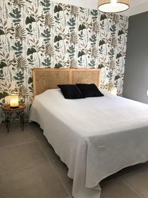 a bedroom with a bed with a white bedspread at Gîte 6 pers en Provence avec grande piscine partagée avec 2nd gîte - 6 pers house in Provence with a large swimming pool to be shared with a 2nd house in Cornillon-Confoux