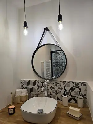 a bathroom with a sink and a mirror at le logis des roues in LʼIsle-sur-la-Sorgue