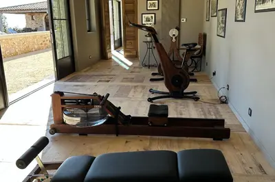 a room with a gym with a treadmill and a exercise bike at Domaine Château du Bois Provence in Lagarde-dʼApt