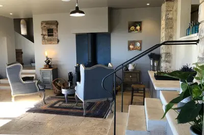 a living room with two chairs and a staircase at Domaine Château du Bois Provence in Lagarde-dʼApt