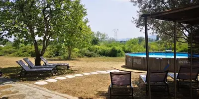 a group of chairs and a pool in a yard at Mas Bruneau in Noves