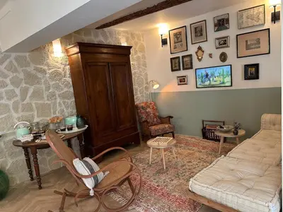 a living room with a couch and a table and chairs at Les Romarins - 5 chambres in Lauris