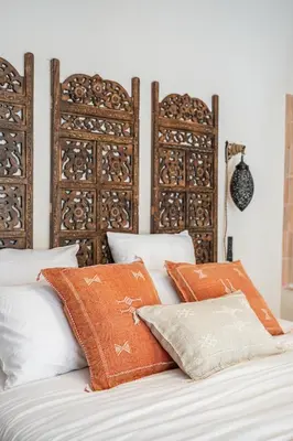 a bedroom with white walls and a large door at La Cour Secrète - Suite Riad Balnéo privé Carpentras in Carpentras