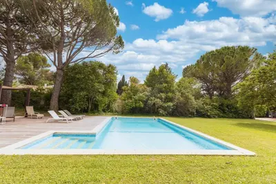 a swimming pool in the yard of a house at Villa des Pres in Eyragues