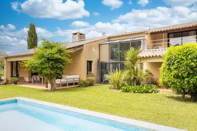 an exterior view of a house with a swimming pool at Villa des Pres in Eyragues