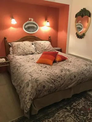 a bedroom with a bed with two pillows on it at La Pasclapierre in Orgon