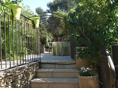 a gate with stairs with a table and a table at La Pasclapierre in Orgon