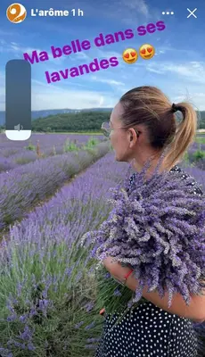 a woman standing in a field of purple flowers at La Pasclapierre in Orgon