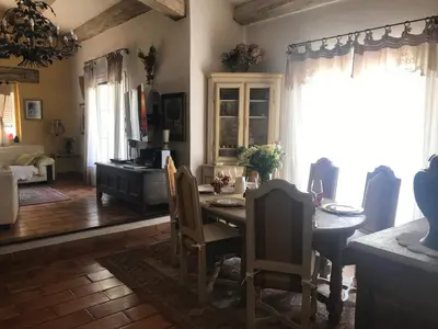 a dining room with a table and chairs at La Pasclapierre in Orgon
