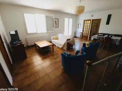 a living room with a couch and a table at Villa Le Pin in Rognes