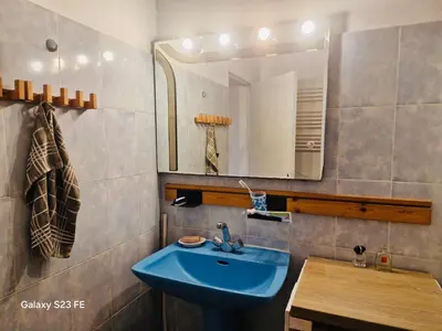 a bathroom with a blue sink and a mirror at Villa Le Pin in Rognes