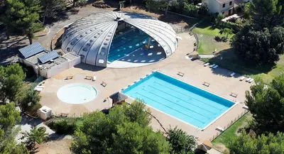 an overhead view of a large swimming pool with a dome at Villa Le Pin in Rognes