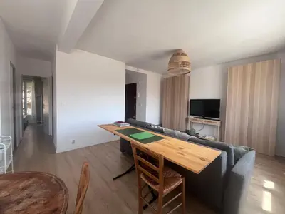 a living room with a table and a couch at Aix centre - Appartement Cosy avec Terrasse et Clim in Aix-en-Provence