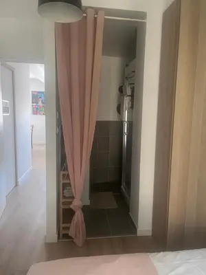 a bathroom with a shower with a pink curtain at Aix centre - Appartement Cosy avec Terrasse et Clim in Aix-en-Provence