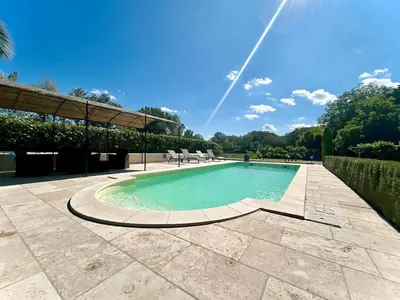 a swimming pool with chairs and a blue sky at Villa 7 chambres, piscine et jardins privés, pas de voisins in Le Thor