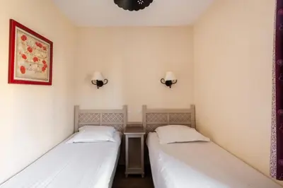 two beds in a small room with white walls at Les Coteaux de Pont Royal en Provence - maeva Home - Maison 3 pièces 6 personnes - Sélection MAE-9993 in Mallemort