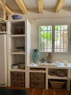 a kitchen with white shelves with vases and a window at Provencal Villa With Panoramic Views In Luberon in Apt