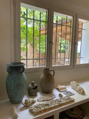 a table with vases and other items on a window at Provencal Villa With Panoramic Views In Luberon in Apt