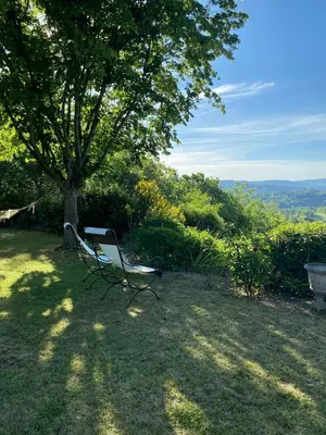 a bench sitting under a tree in the shade at Provencal Villa With Panoramic Views In Luberon in Apt
