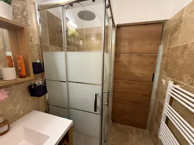 a bathroom with a shower with a refrigerator at Cabanon Lourmarin in Lourmarin