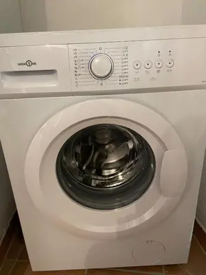 a white washing machine with its door open at Plaisir de vacances in Aix-en-Provence