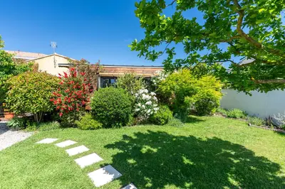 a yard with a house with a lawn sidx sidx sidx at La roulotte de Valou in Noves