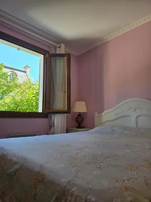a bedroom with a large bed and a window at 3 Bedroom House Terrace Park & Free Parking in Aix-en-Provence
