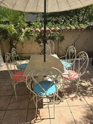 a table and chairs with an umbrella on a patio at 3 Bedroom House Terrace Park & Free Parking in Aix-en-Provence