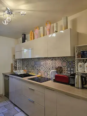 a kitchen with white cabinets and a counter top at 3 Bedroom House Terrace Park & Free Parking in Aix-en-Provence