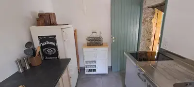 a kitchen with a counter top and a refrigerator at Location Le Tilleul in Pélissanne