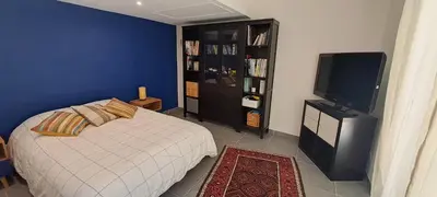 a bedroom with a bed and a flat screen tv at Location Le Tilleul in Pélissanne