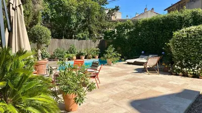 a patio with chairs and a pool with plants at Saint-Jean-des-Cèdres in Aix-en-Provence