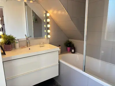 a bathroom with a sink and a tub and a mirror at Saint-Jean-des-Cèdres in Aix-en-Provence