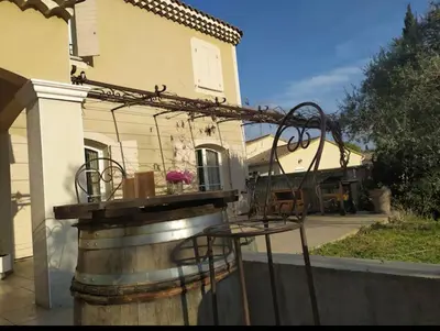 a wine barrel in front of a house at Belle bastide provençale in Noves