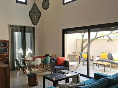a living room with a couch and a table and chairs at Loft en Provence - Terrasse-Climatisation-Proche Golf et Luberon in Vernègues