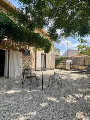 a picnic table and chairs in a courtyard at Small house in Provence in Aix-en-Provence