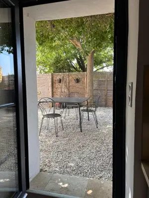 a patio with a chair and a bench and a fence at Small house in Provence in Aix-en-Provence
