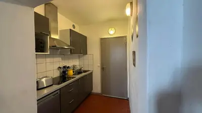 a small kitchen with a sink and a stove at Studio dans le centre ancien in Carpentras