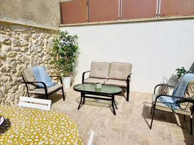 a patio with a couch and chairs and a table at L'Ecrin de Mérindol in Mérindol