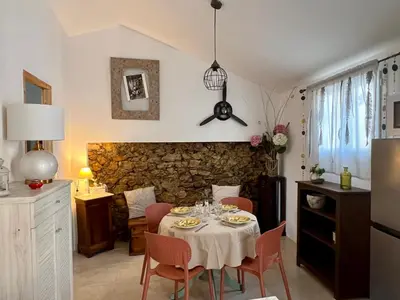 a kitchen and dining room with a table and chairs at L'Ecrin de Mérindol in Mérindol