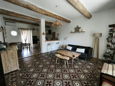 a living room with a table and a couch at La dominique in Villes-sur-Auzon