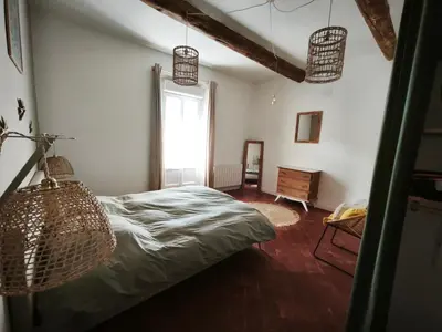 a bedroom with a bed in a room with a window at La dominique in Villes-sur-Auzon