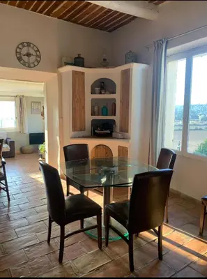 a dining room with a glass table and chairs at Maison de vacances en pleine nature in Aurons
