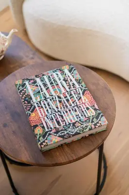 a book sitting on top of a wooden table at Havre de Paix en Provence in Aix-en-Provence