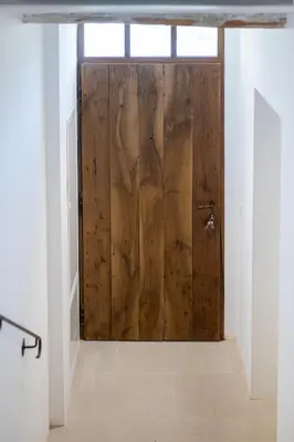 a wooden door in the middle of a room at Havre de Paix en Provence in Aix-en-Provence