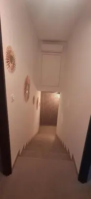 a hallway with stairs and a mirror on the wall at Maison de campagne in Salon-de-Provence