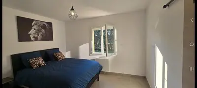 a bedroom with a blue bed and a window at Maison de campagne in Salon-de-Provence