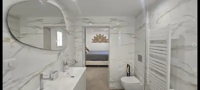 a white bathroom with a sink and a mirror at Maison de campagne in Salon-de-Provence