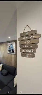 a wooden sign hanging on a wall in a room at Maison de campagne in Salon-de-Provence