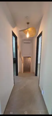 an empty room with a ceiling fan and a hallway at Maison de campagne in Salon-de-Provence